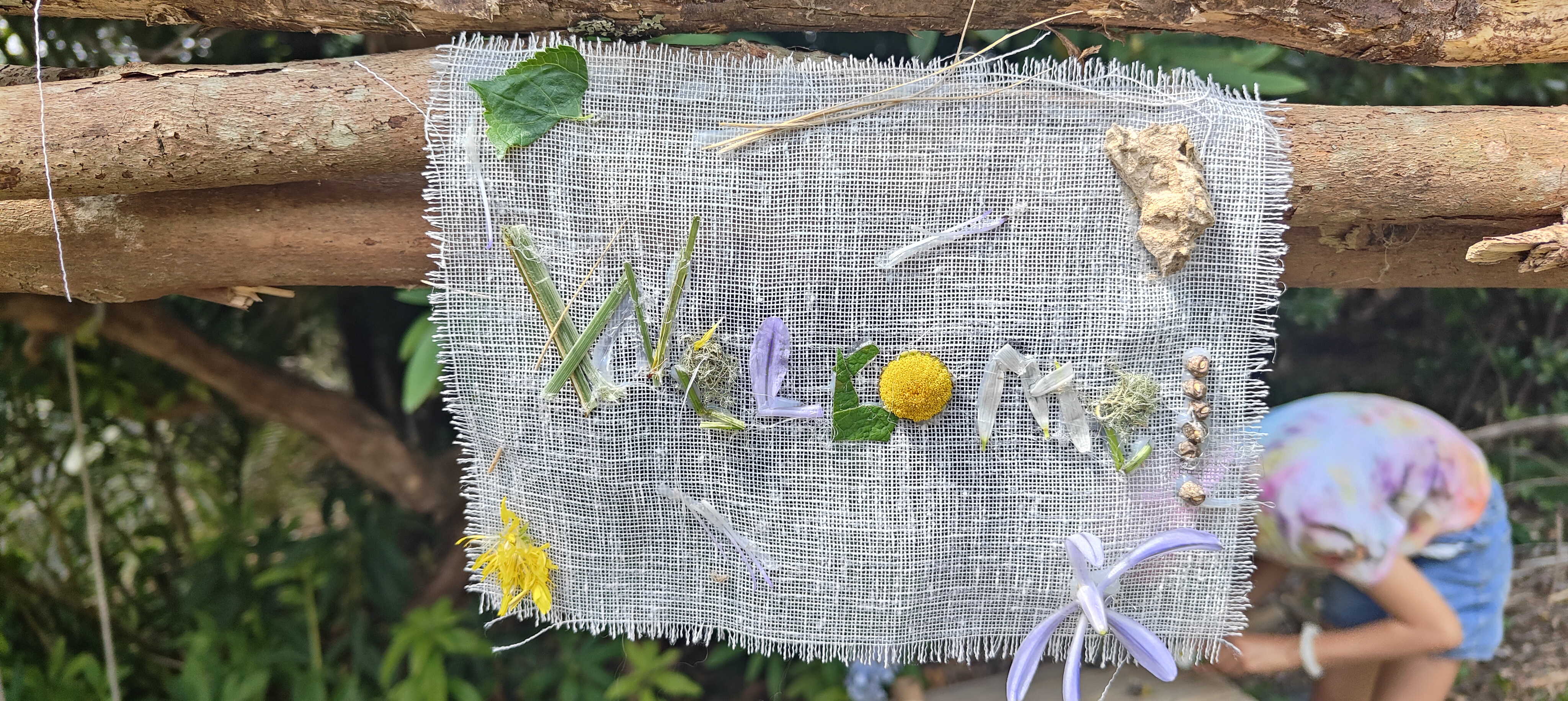 Hand-made welcome sign from natural materials on burlap