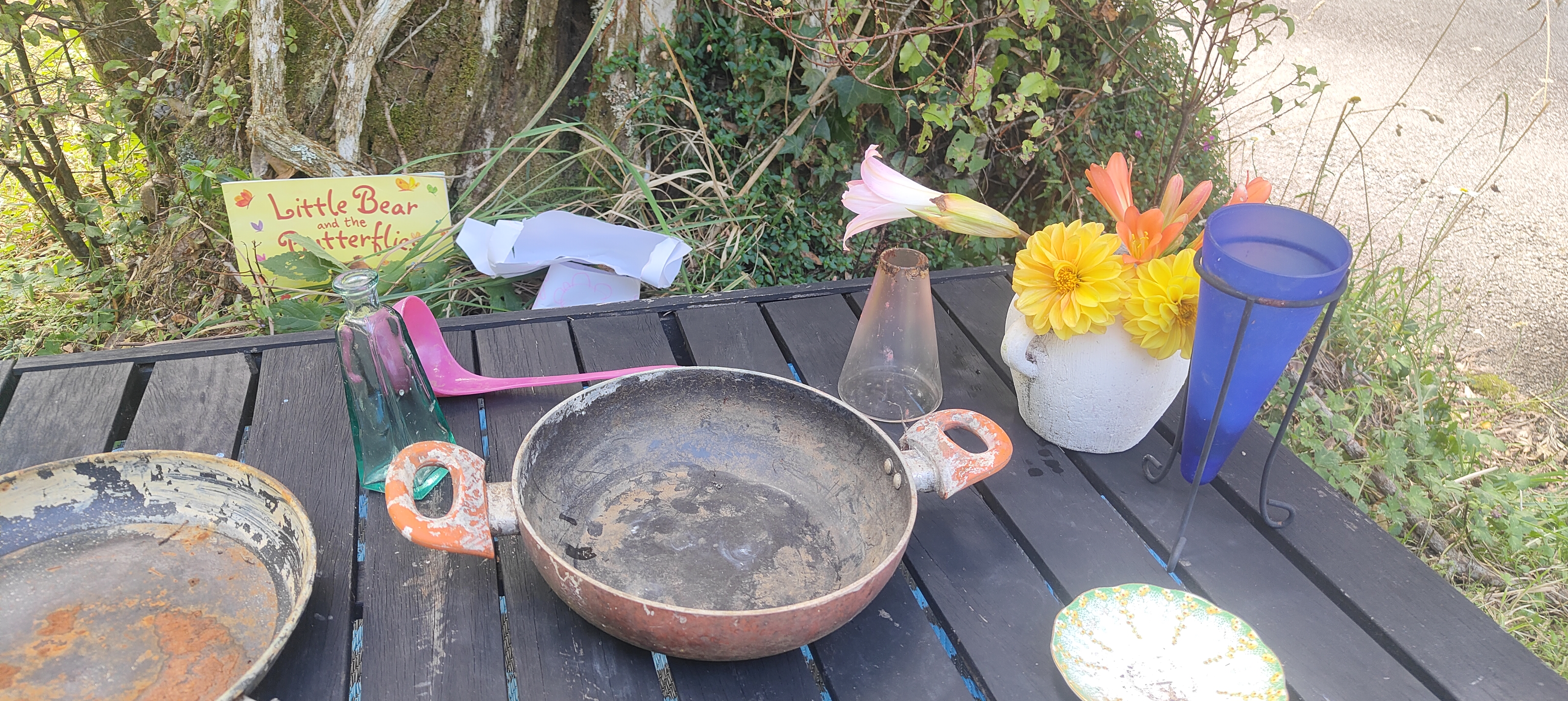 Outdoor craft table with books and flowers at The Bush Base