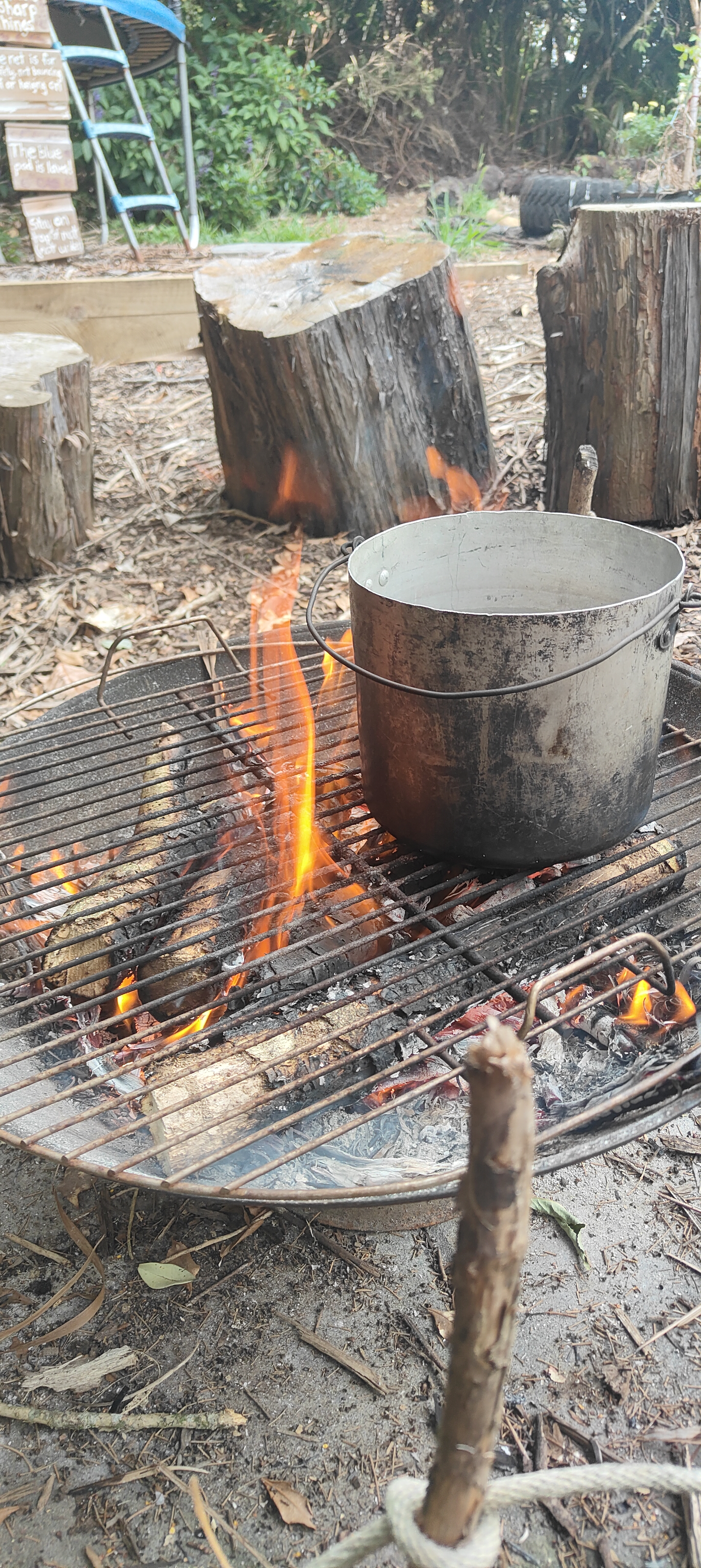 Pot cooking over an open fire at The Bush Base