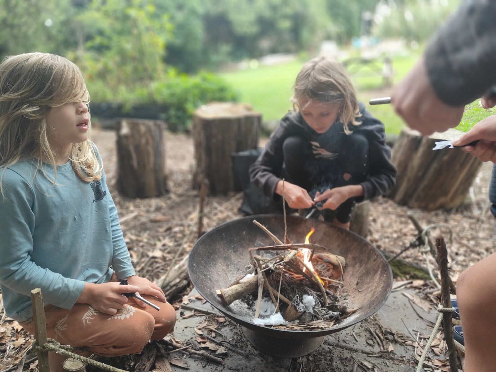 Children learning to make fire at The Bush Base
